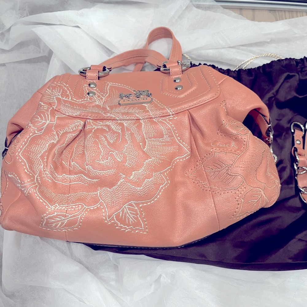 This is coach limited addition. Pink with stitched flower , medium size